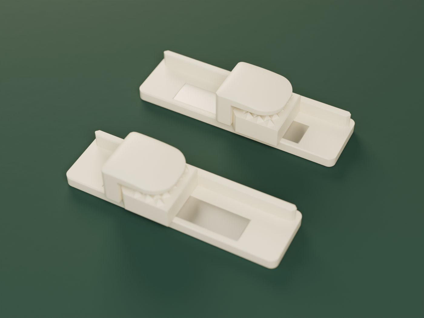 The MatSnap kit in ivory: two wall mounts, each with a clamp resting on it, on a deep green cloth