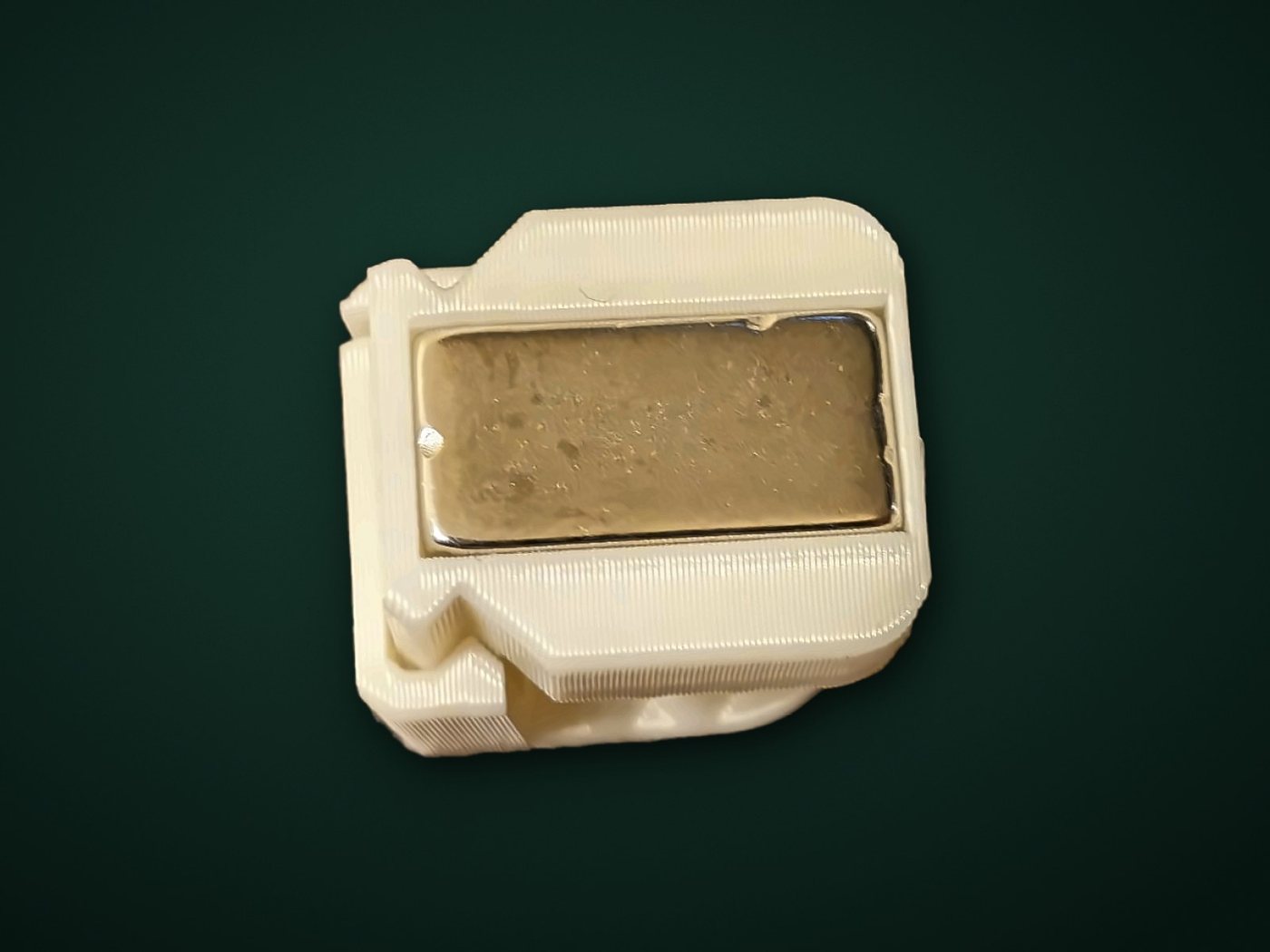 The back of a real clamp, showing its rectangular magnet set flush into the plastic