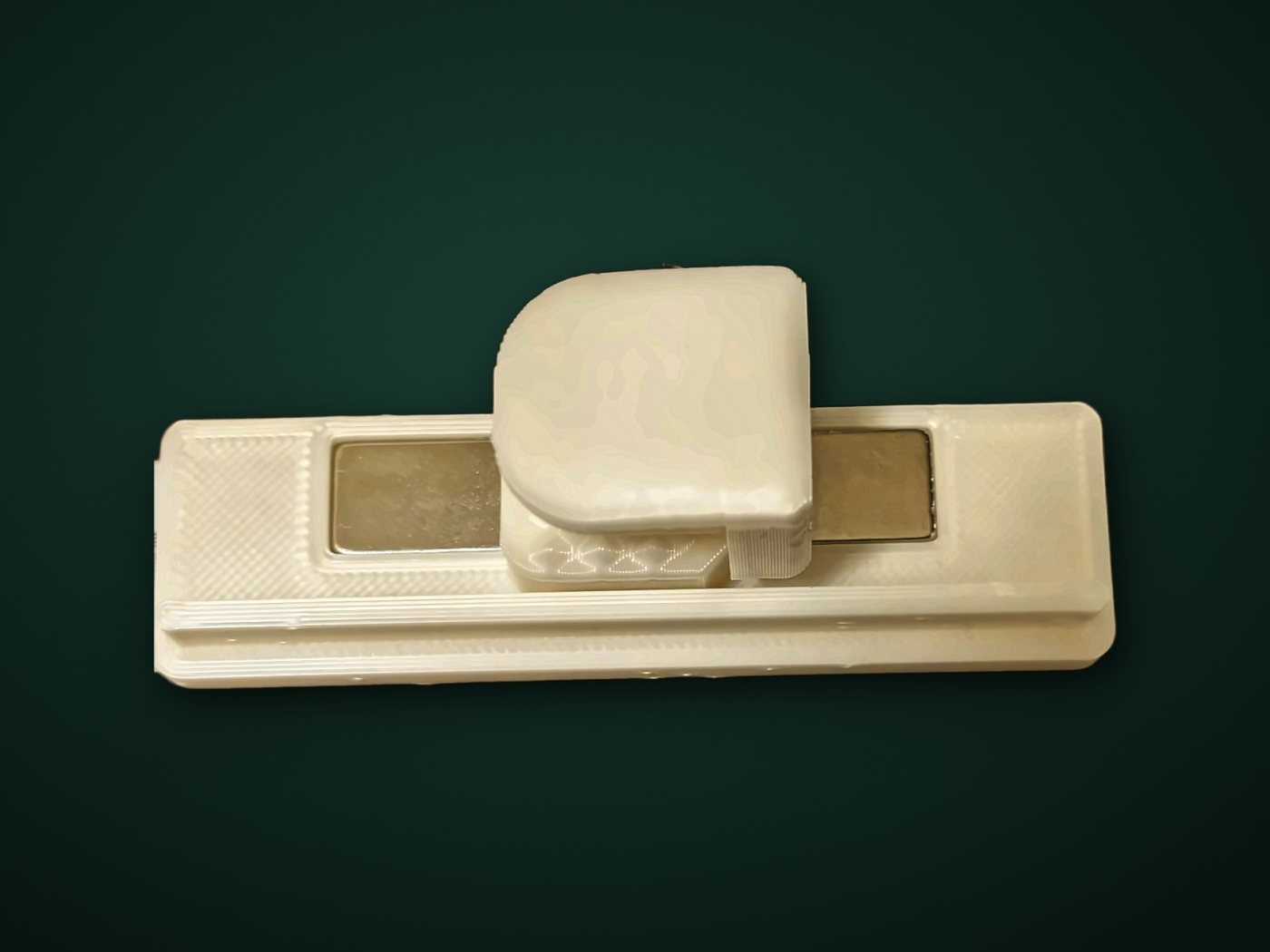 A real ivory clamp resting on a wall mount with its magnet showing