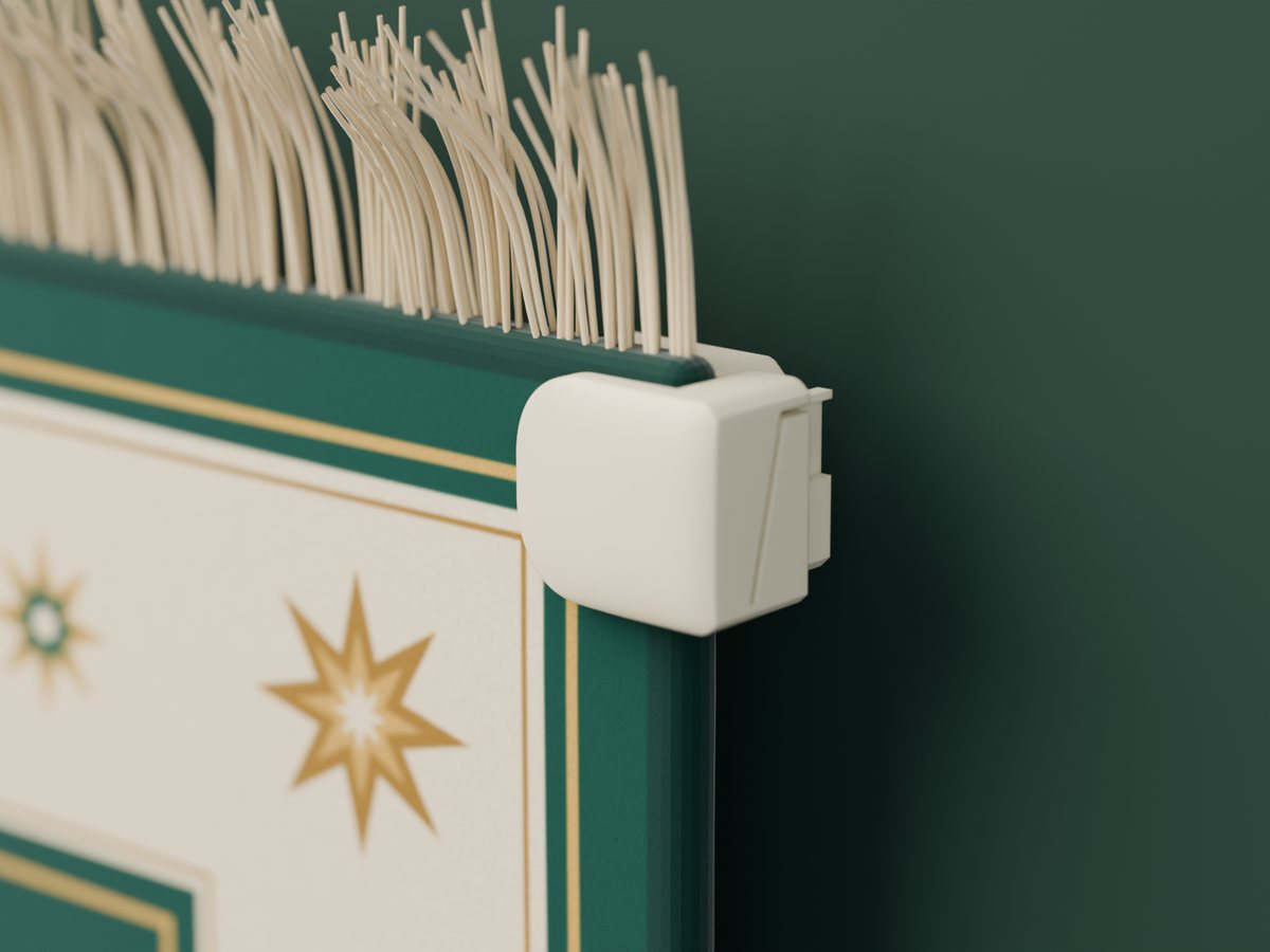 A MatSnap clamp gripping the corner of a prayer mat, just below the tassels